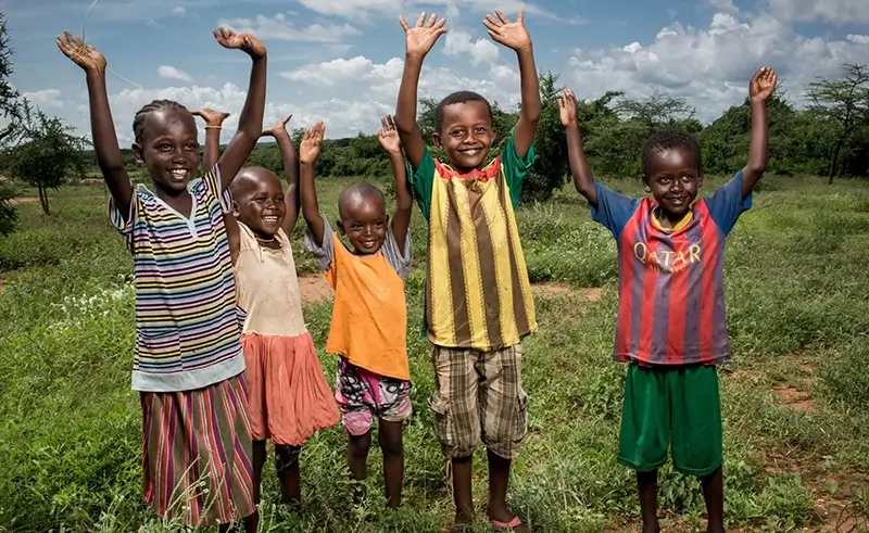 Kids raising their hands in Ethiopia.