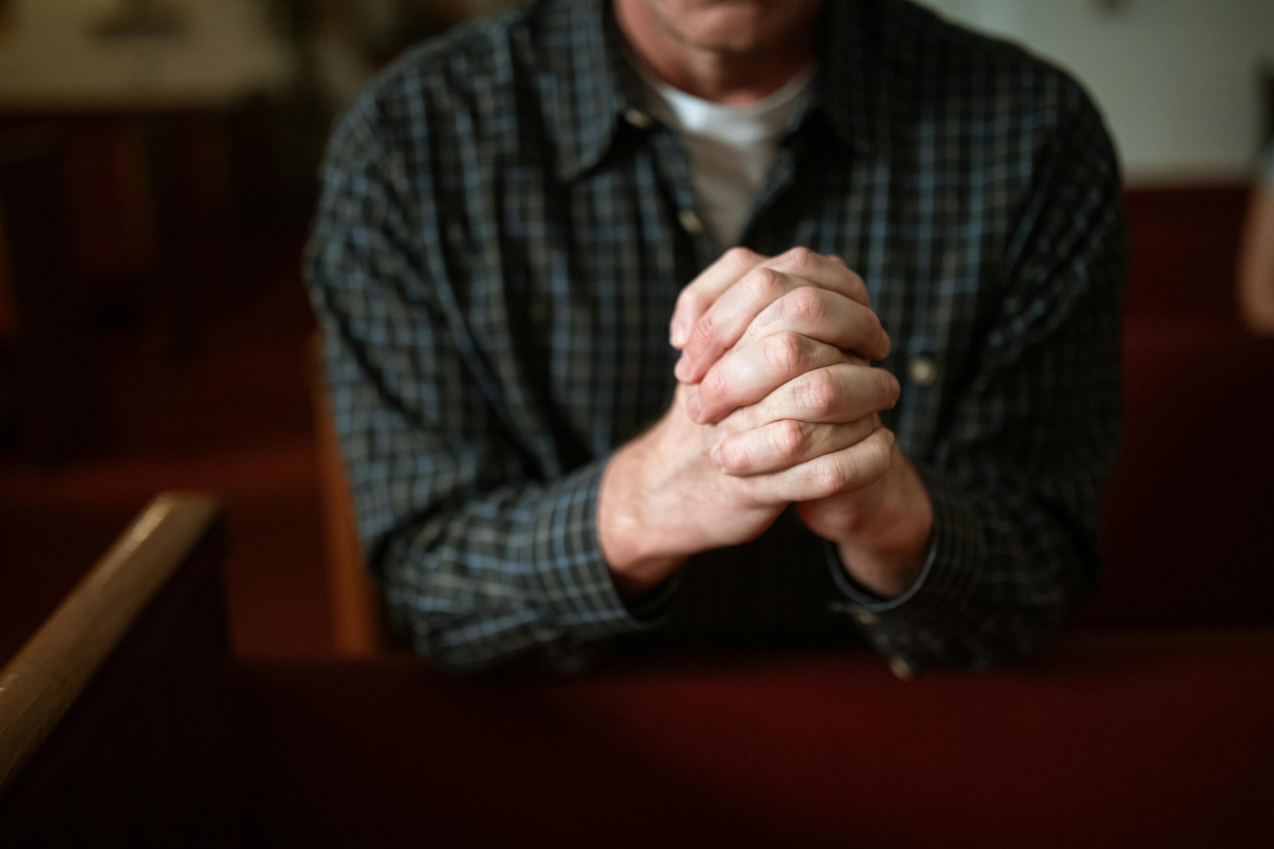 man praying in church.