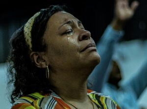 Woman in tears praying.